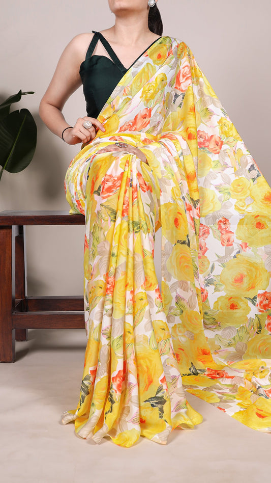 Close-up of a woman in yellow floral satin saree.