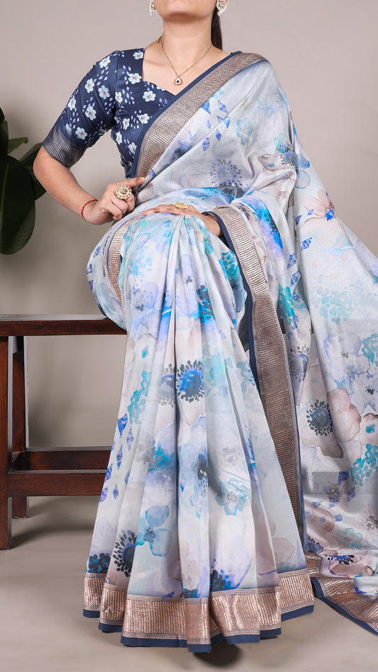 Full view of a woman draped in a stylish blue and white floral printed Tussar silk saree.