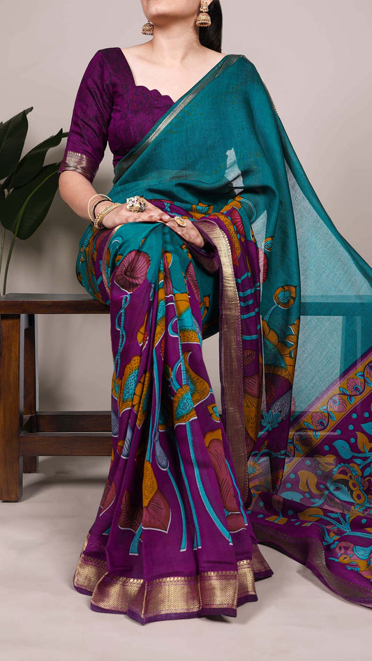 Elegant handcrafted saree in teal and purple with floral motifs.