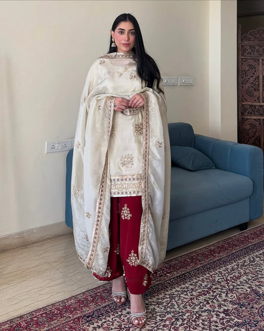 Woman wearing Rangbhoomi Silk Splendor Party Wear in cream and maroon with embroidery.
