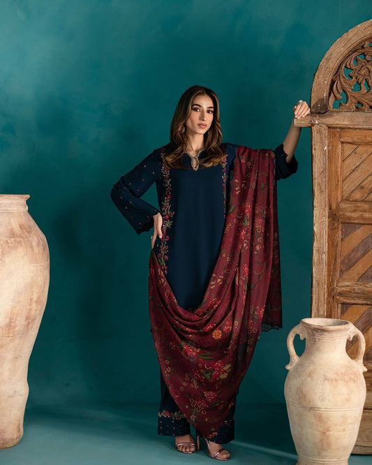 Full view of navy blue embroidered Farsi salwar set with statement maroon floral dupatta draped.