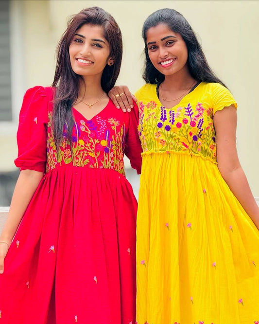 Close-up of women in red and yellow Floral Embrace dresses. Rangbhoomi summer collection.