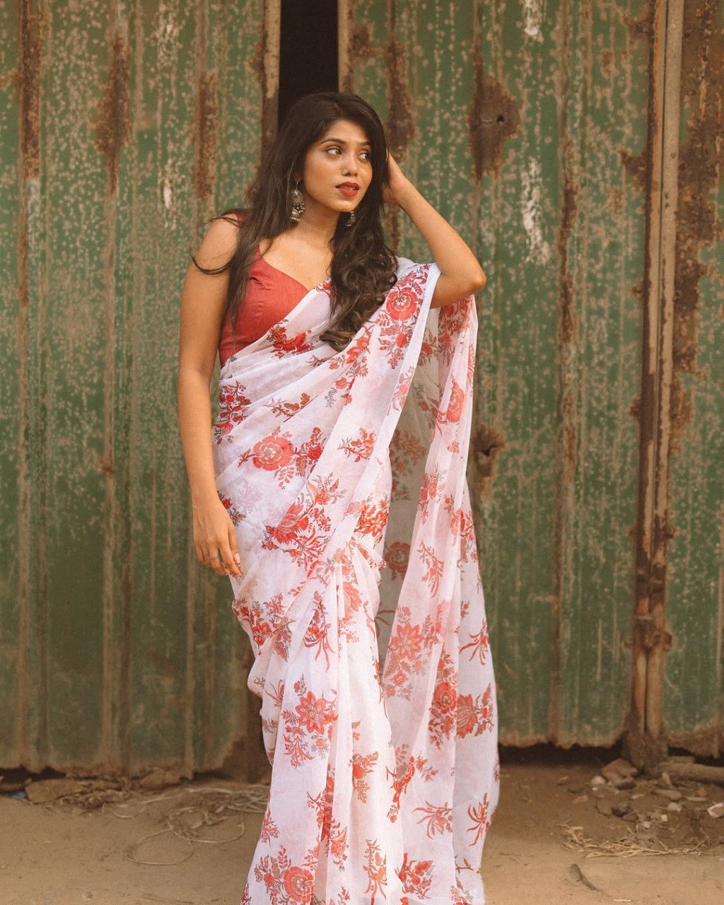 Woman wearing a ready-to-wear off white floral saree in georgette.