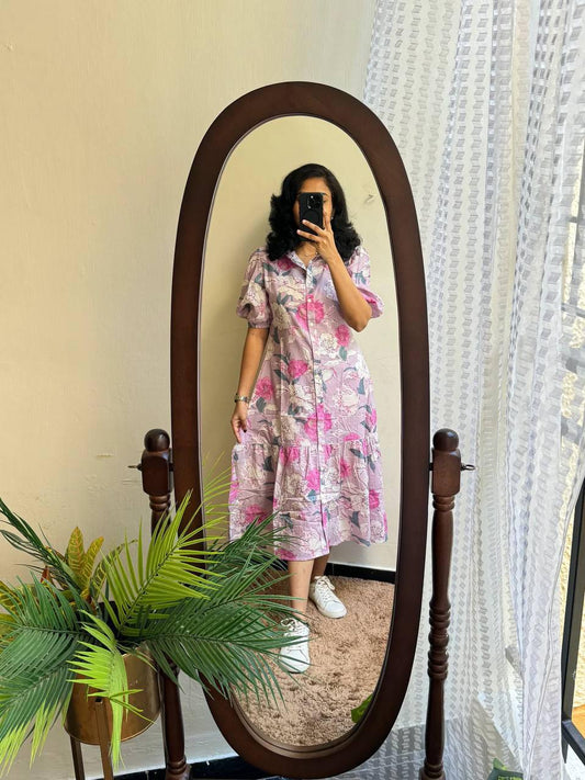Full-length view of a woman in the Lilac floral maxi dress in front of a mirror.