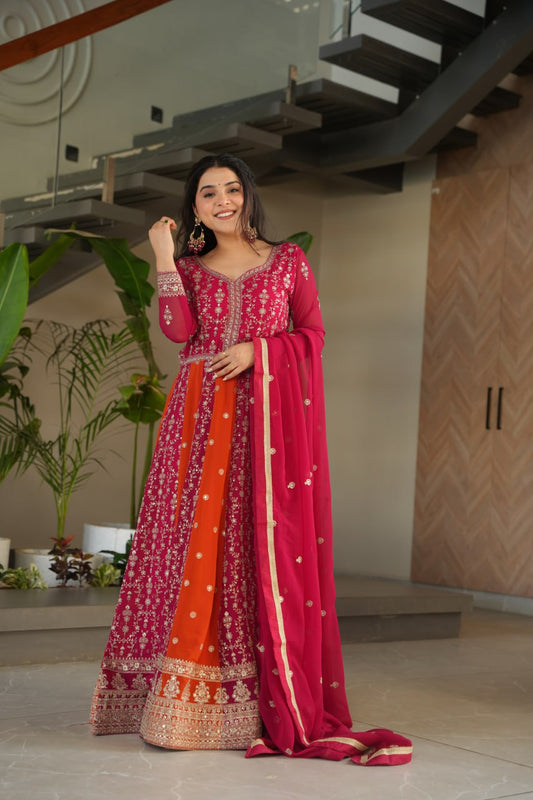 Elegant woman wearing a pink and orange embroidered designer gown with dupatta.