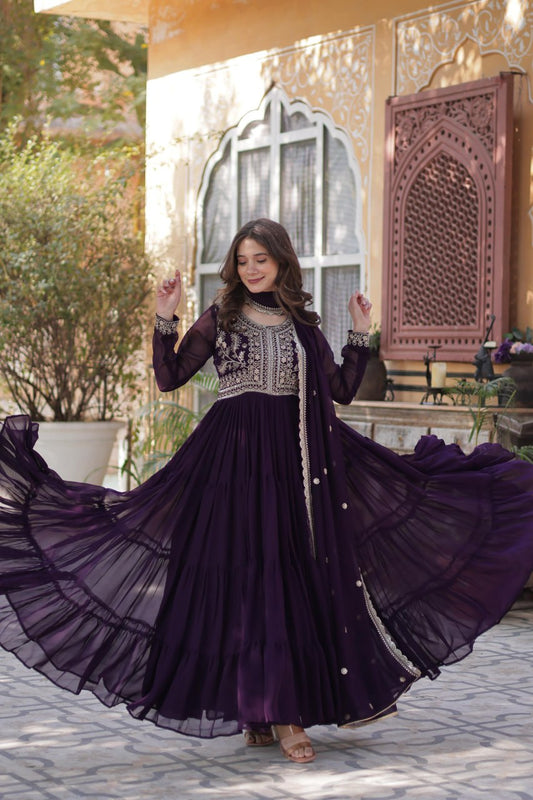 Flowing purple Georgette gown with pearl embroidery and wide flair.
