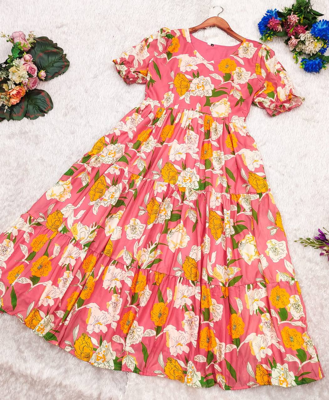 Pink floral cotton maxi dress laid flat, displaying the full pattern and design.