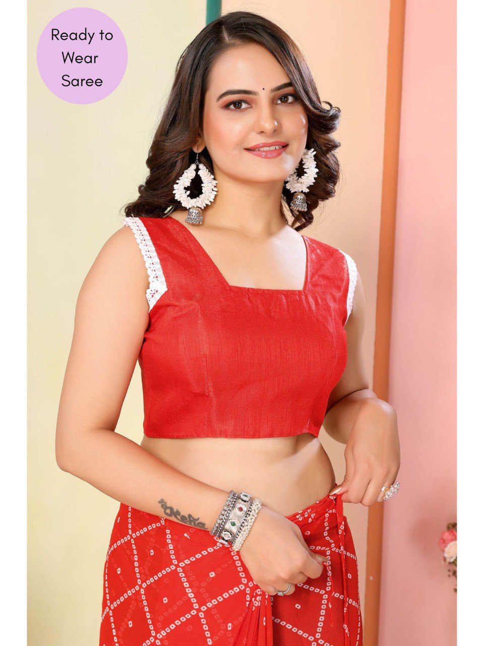 Stylish sleeveless blouse with lace trim paired with an orange geometric georgette saree.