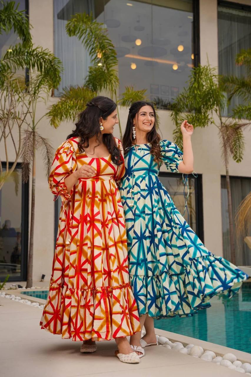 Two women wearing Sajda Maxi Dresses in red-orange-white and blue-dark blue-white.