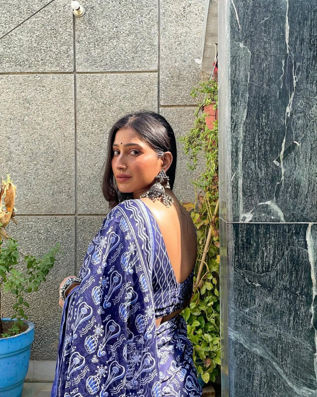 Comfortable blue and white cotton saree for festive occasions.