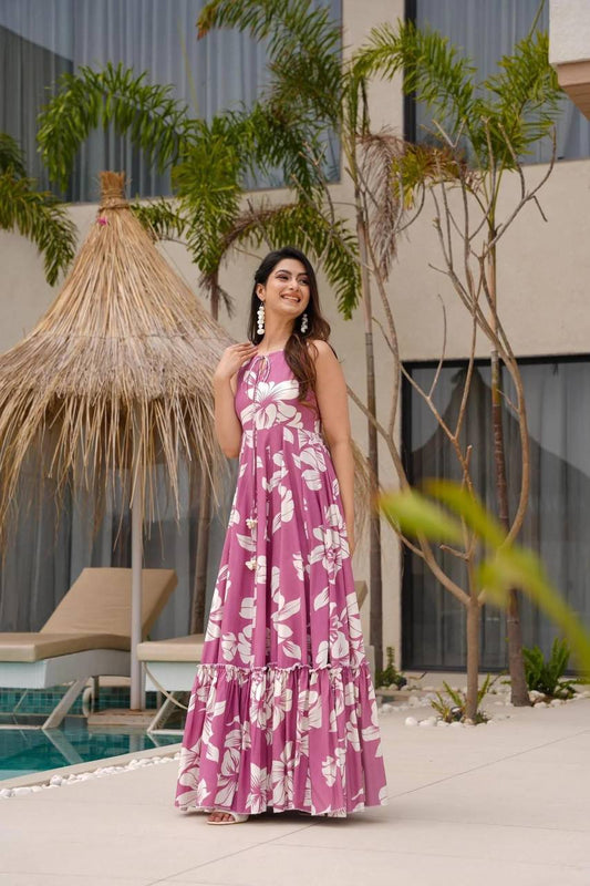 Model wearing a pink blossom cotton dress, South Indian style, by a pool.