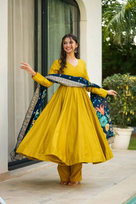 Yellow flared Nayab suit set with full sleeves and navy printed dupatta, model twirling and smiling.