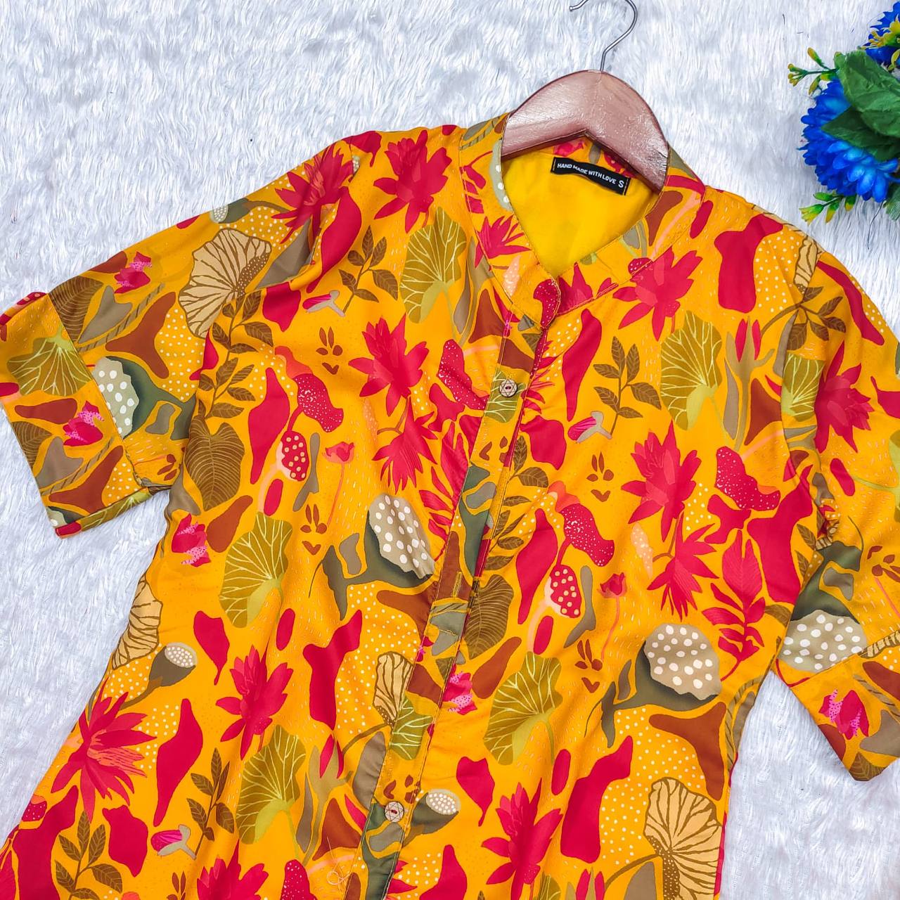 Close-up of Yellow Forest Kurti’s vibrant floral design and button front, highlighting cotton fabric.