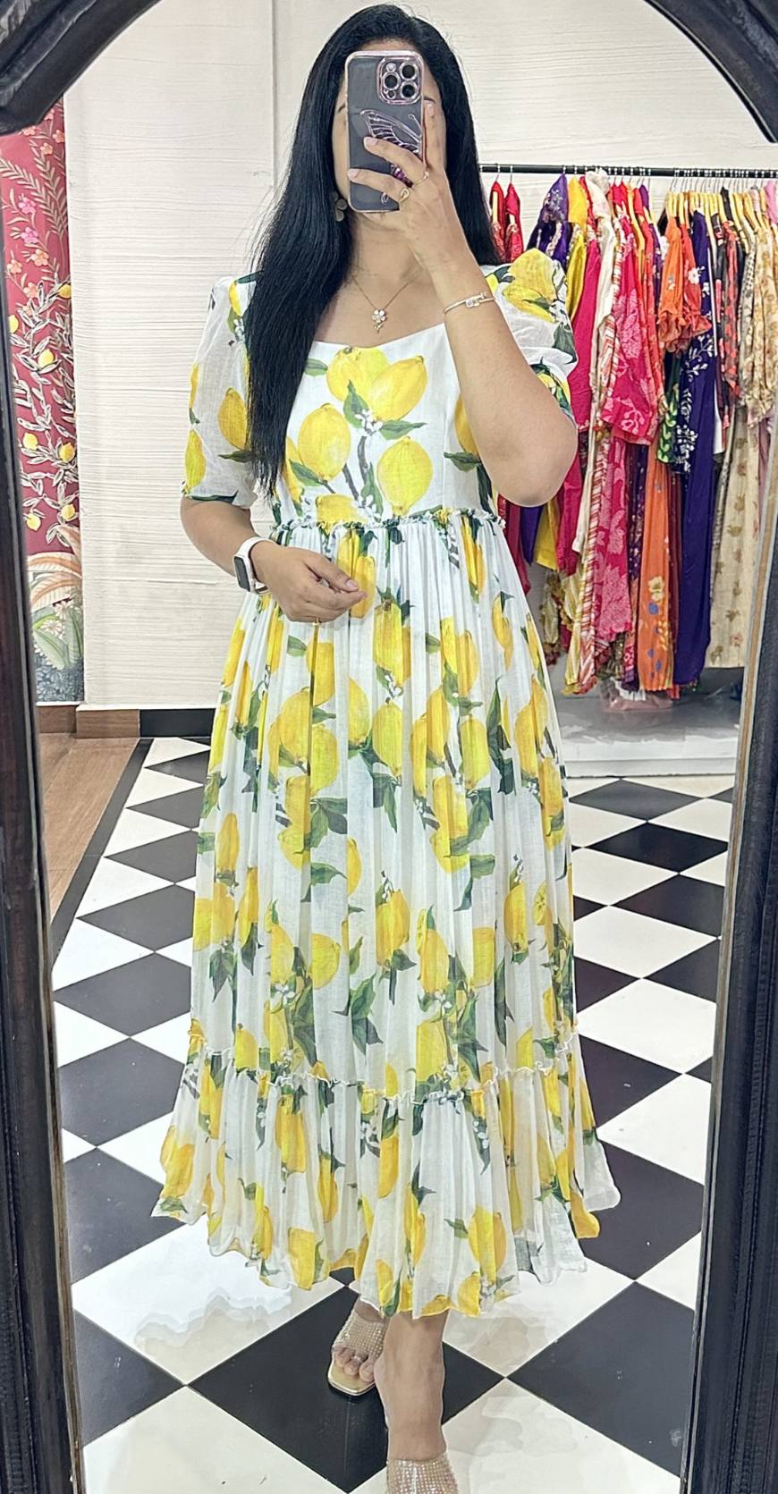 Model wearing lemon print maxi dress with jewelry.