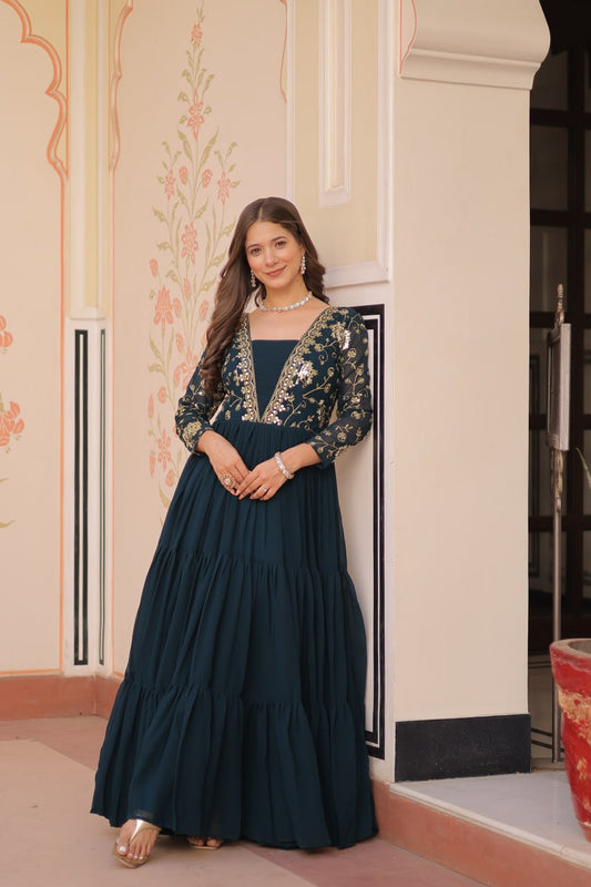 Model wearing green premium gown with gold embroidery