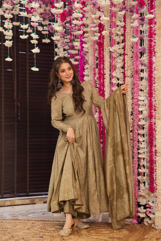 Model showcasing the silver Bandhani Anarkali suit, holding the dupatta and smiling.