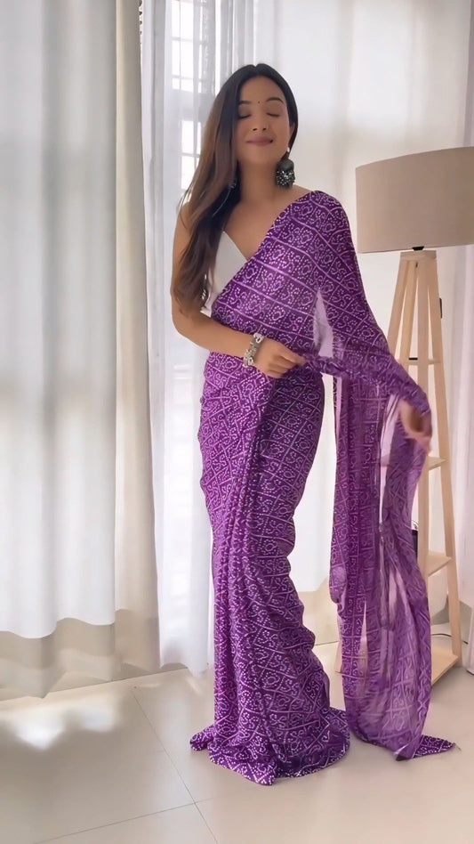 Woman gracefully presenting the flowing purple printed georgette saree.