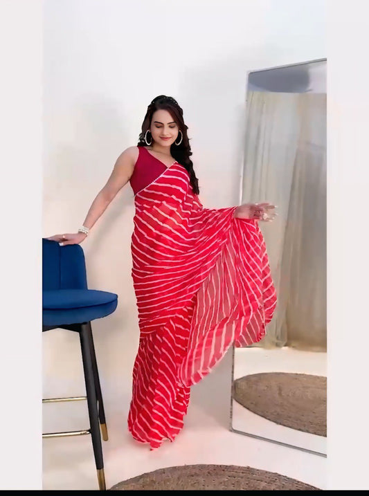 Full view of a woman in a ready-to-wear red and white leheriya saree with adjustable waistline.