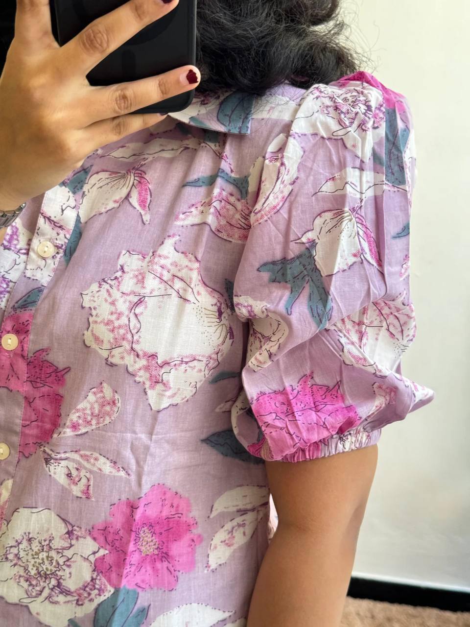Detailed view of the Lilac floral maxi dress's sleeve and button detail.