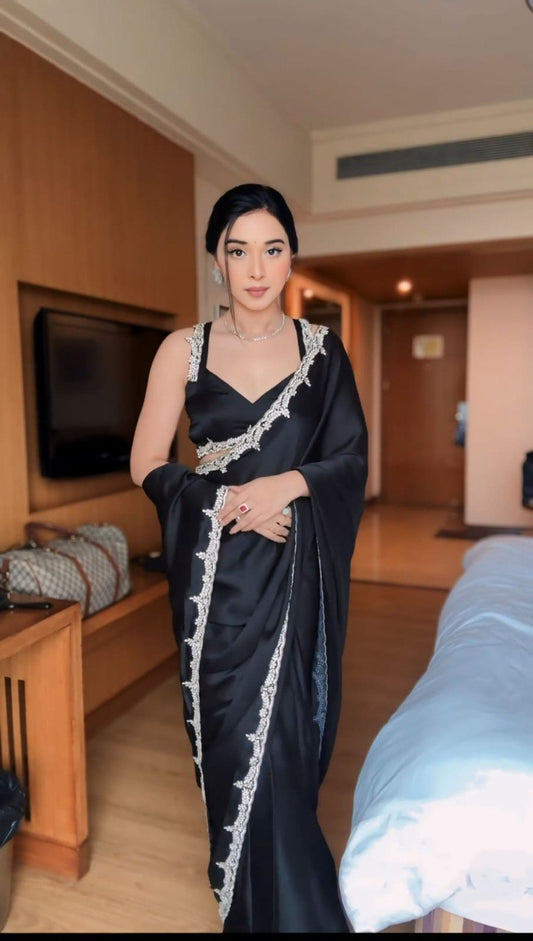 Woman in a black Rangoli Silk Ready To Wear Saree with white border, stitched blouse.