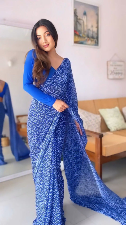 Model showcasing the ready to wear blue georgette saree in a home setting.