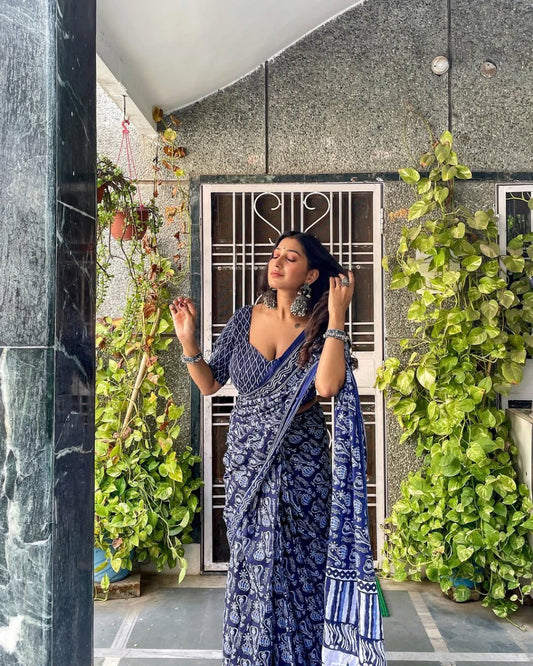 Woman in stylish blue and white printed cotton saree with silver earrings.