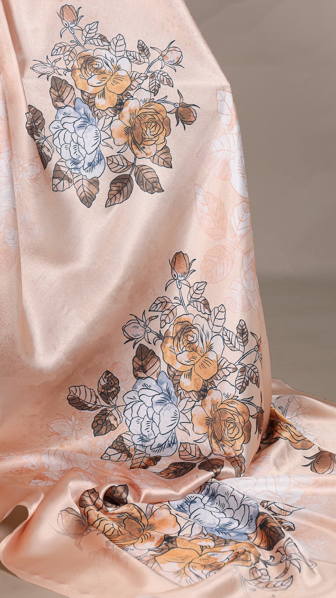 Satin saree with vibrant floral prints, close-up view.