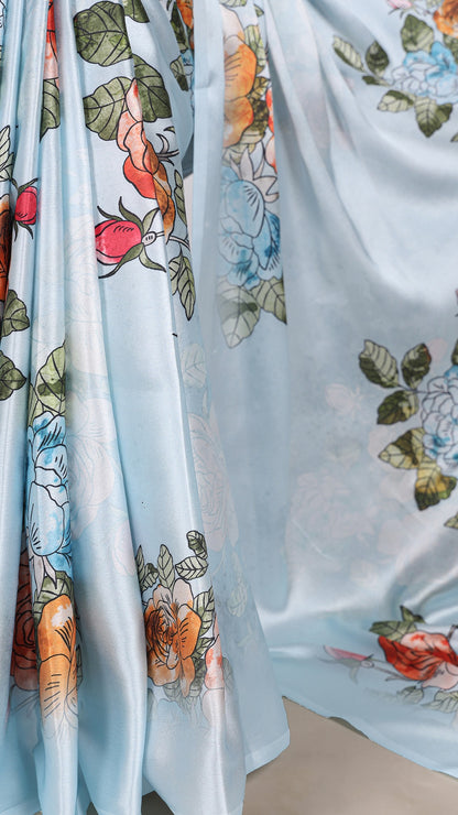 Flowing satin saree with colorful floral patterns.