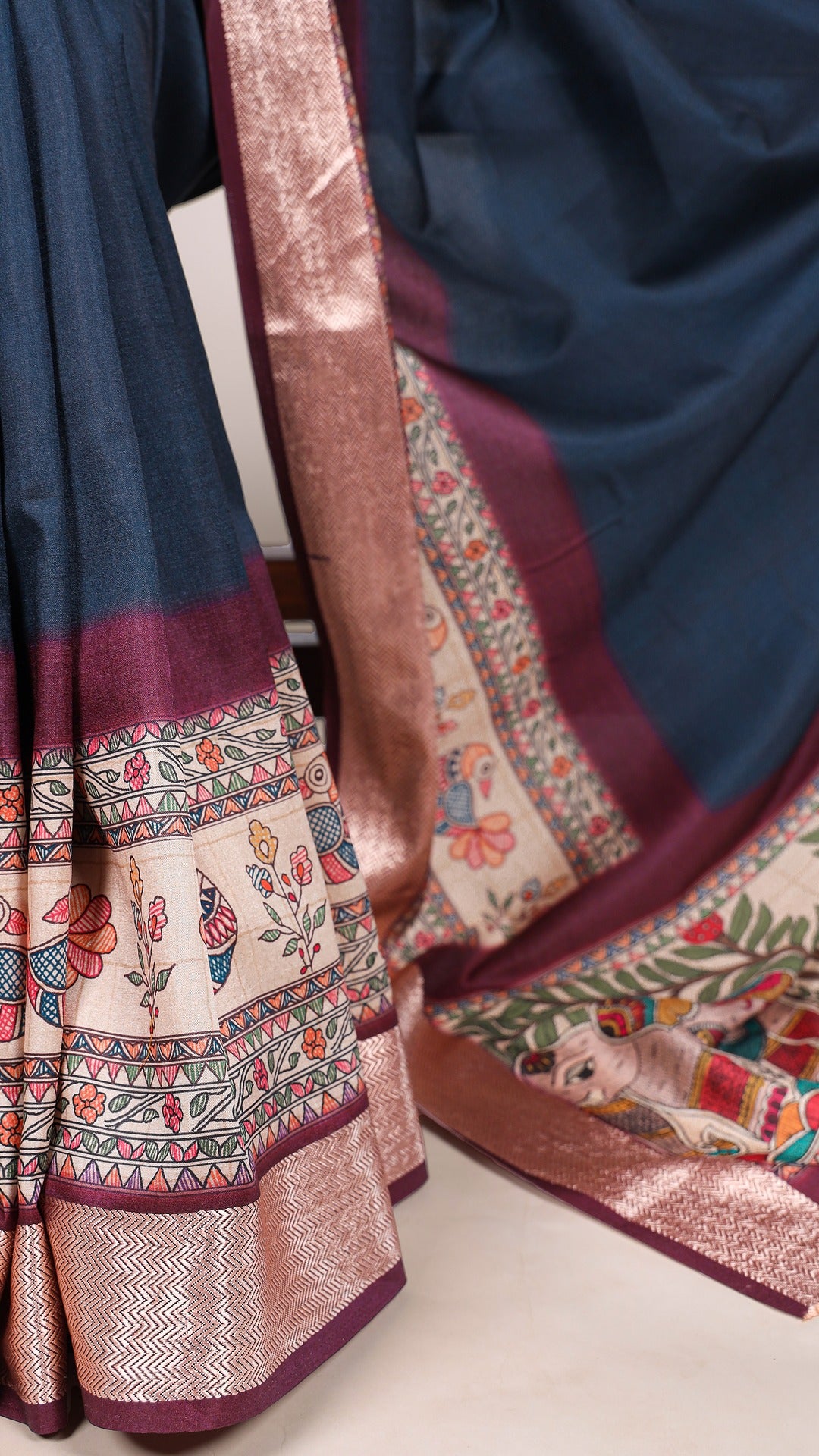 Detailed tasar silk saree border with printed floral and animal designs.