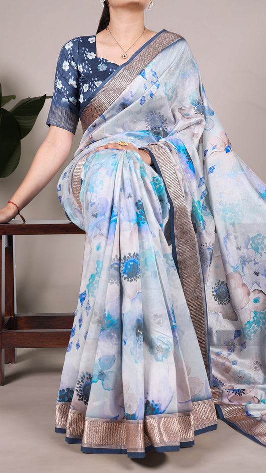 Model wearing a floral printed Tussar silk saree in shades of blue and white.