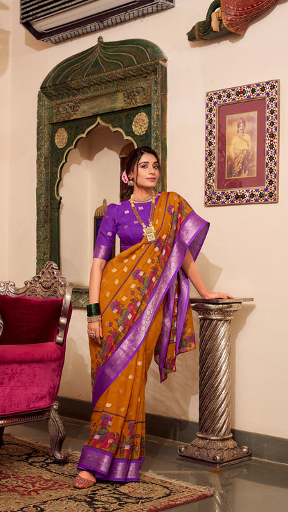 Model in mustard yellow saree with purple border and matching blouse.