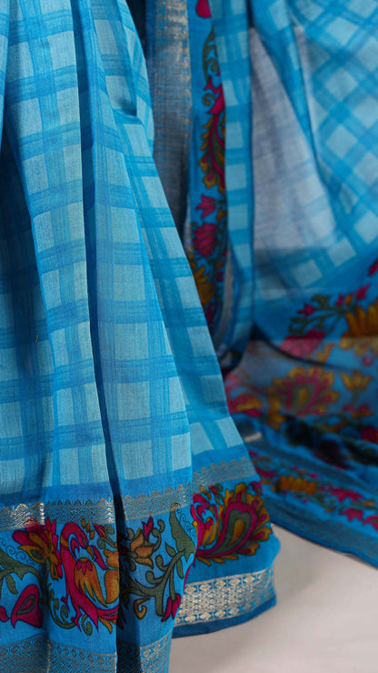 Draped blue checked saree with floral and bird design border.