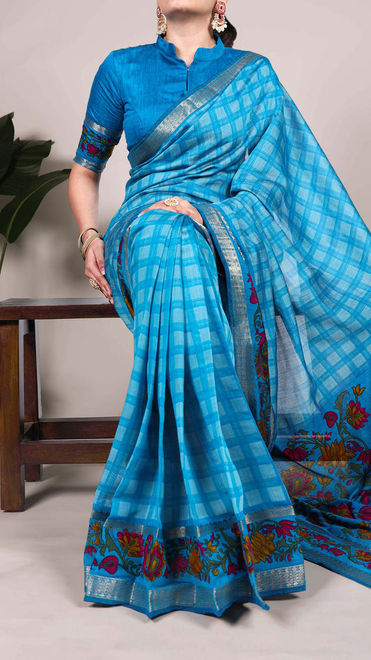 Model wearing a blue checked saree with an embroidered border.
