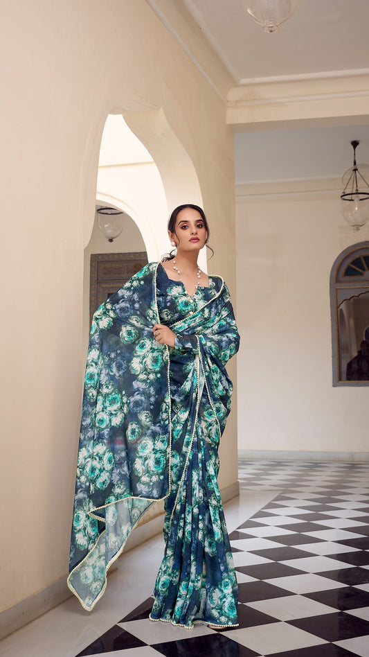 Elegant navy blue floral saree with delicate pearl border detailing.