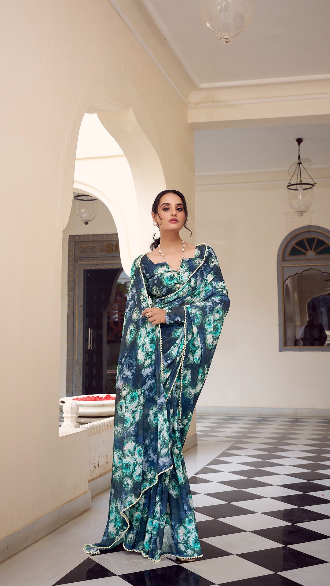 Model showcases drape and style of the lightweight blue floral saree.