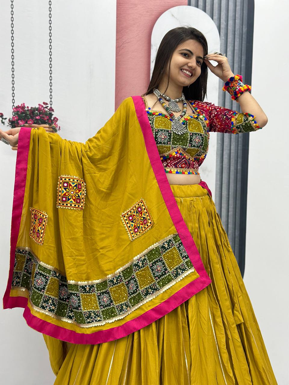 Close-up of Gamthi work blouse and dupatta with mirror accents and pink border details.