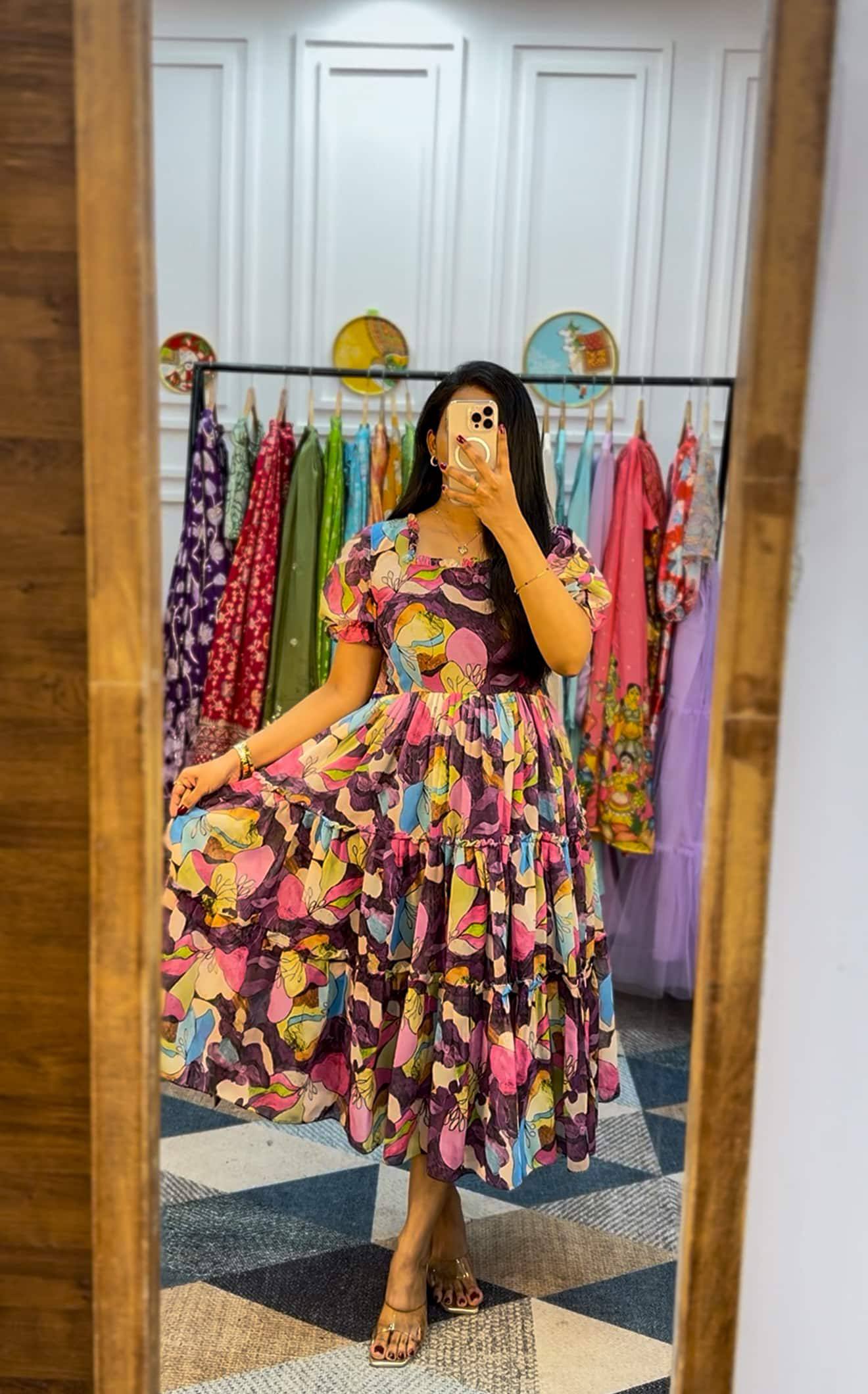 Woman in mirror wearing tiered floral georgette maxi dress