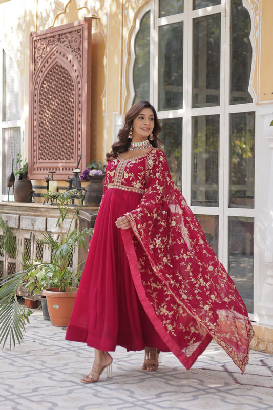 Elegant pink Indian gown with zari embroidery and matching dupatta.