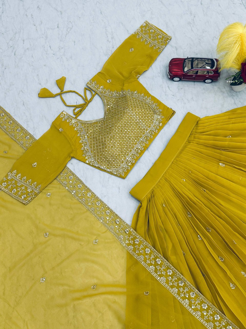 Flat lay of the lime green embroidered georgette lehenga choli set.