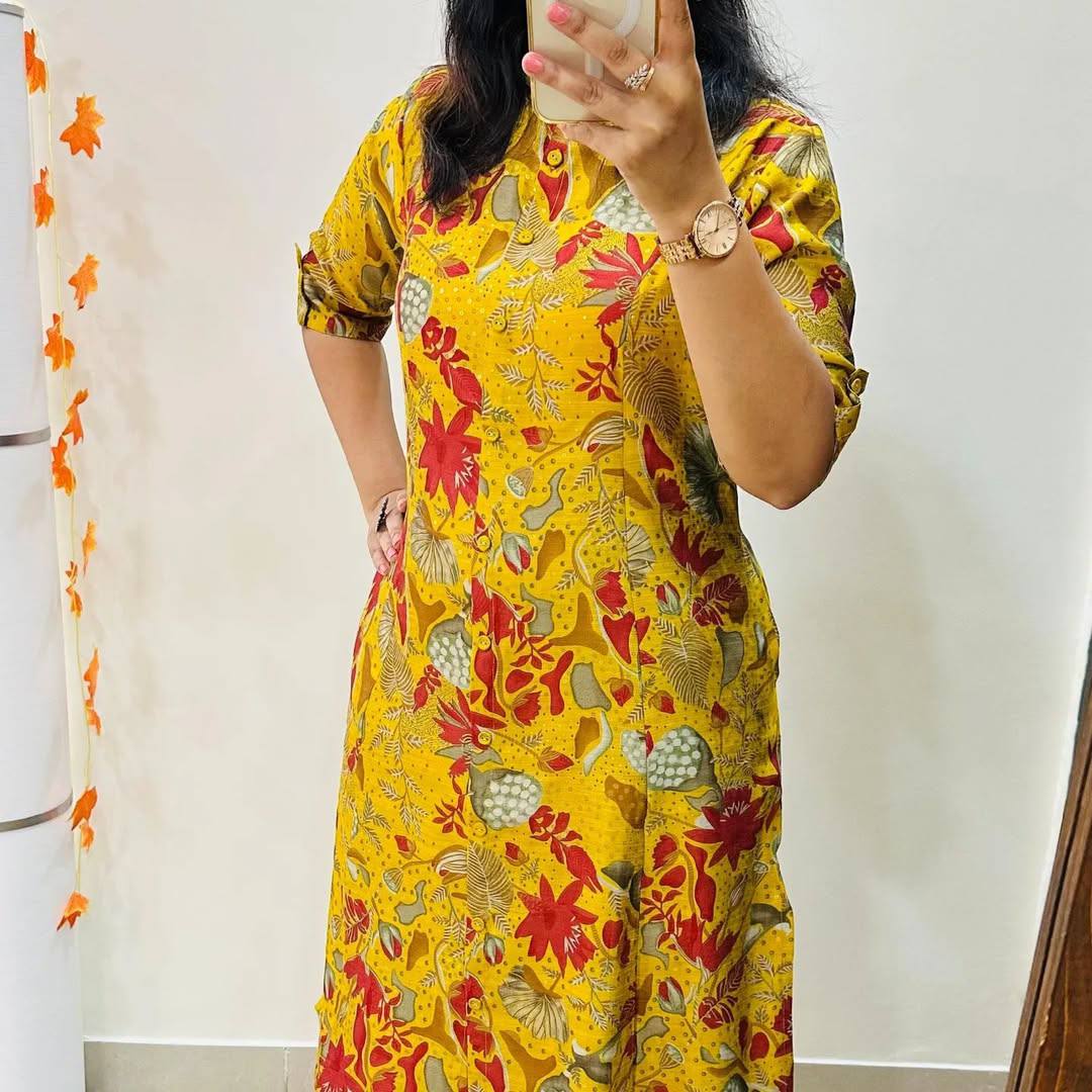 Woman wearing Yellow Forest Kurti with bold floral print and short sleeves, perfect for casual or day wear.
