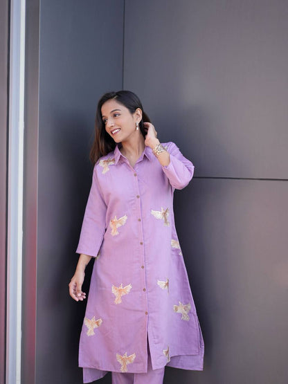 Model in lavender Kurti Palazzo set with gold bird embroidery.