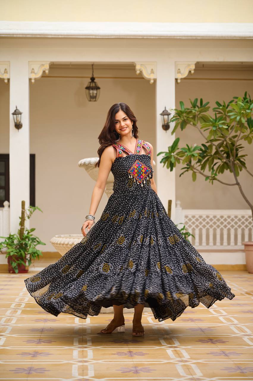 Woman wearing classic black Bandhani Gamathi work gown with mirror work and festive flair.