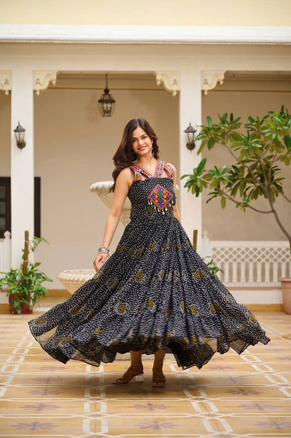 Woman wearing classic black Bandhani Gamathi work gown with mirror work and festive flair.