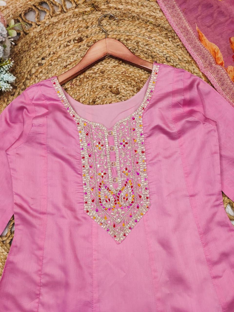 Close up of the embroidered neckline on the pastel pink Anarkali kurta.