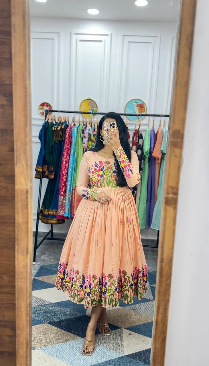 Model wearing the peach Floral Elegance Maska Cotton Dress with detailed embroidery.