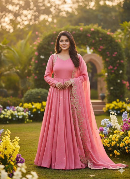 Full-length shot of a model wearing a wine Anarkali gown with intricate embroidery.