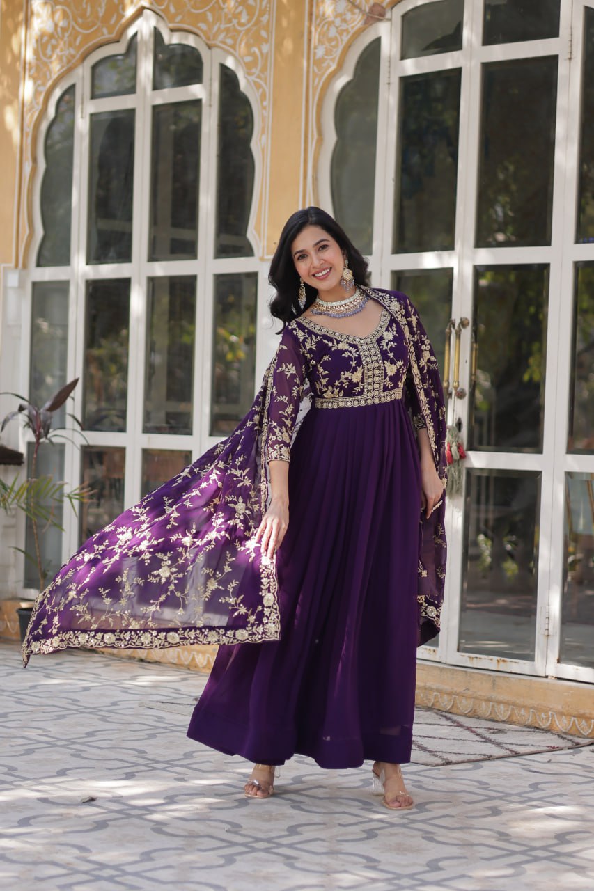 Elegant purple Indian gown with zari embroidery and matching dupatta.