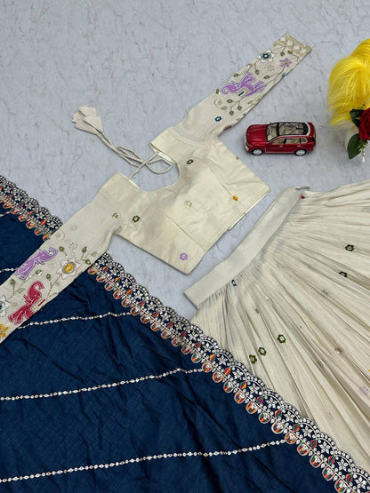 Top-down view of the off-white lehenga choli and navy blue dupatta set.