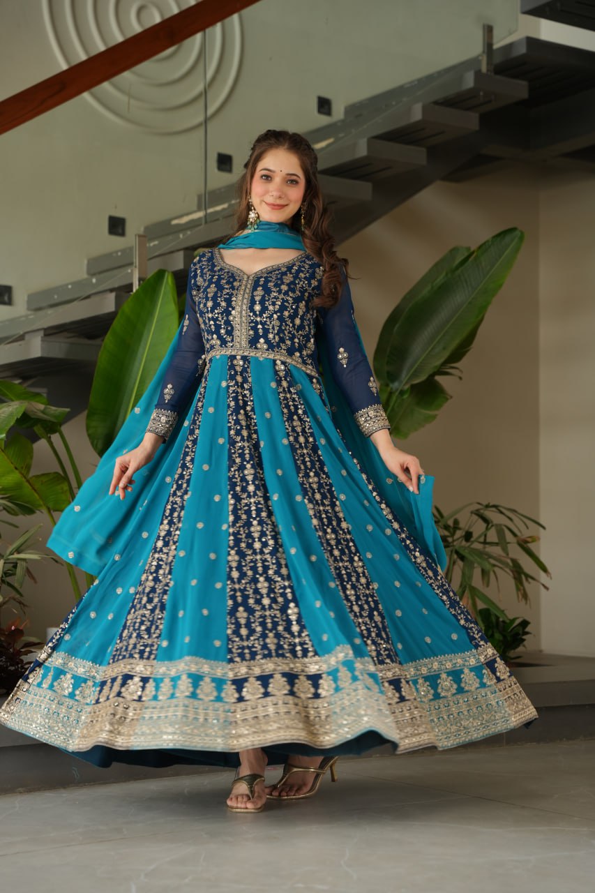 Woman in a blue and gold gown, showcasing the full flair and design.