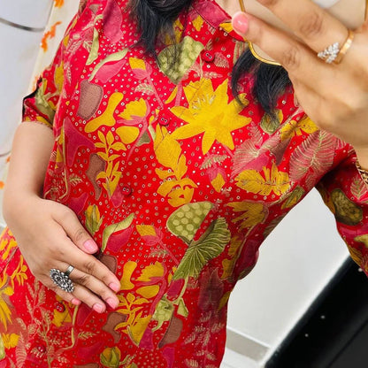 Close-up of multicolor floral print and button placket on red cotton kurti, showing fine details.